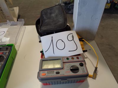 a small electronic device sitting on a table with a note on it