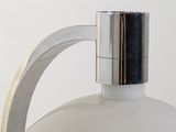 a white bottle with a metal handle on a white surface