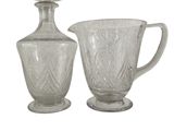 two glass vases sitting next to each other on a white surface