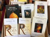 several books are stacked on top of each other in a box