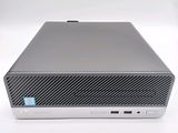 the back of a computer with a keyboard and mouse on a white surface