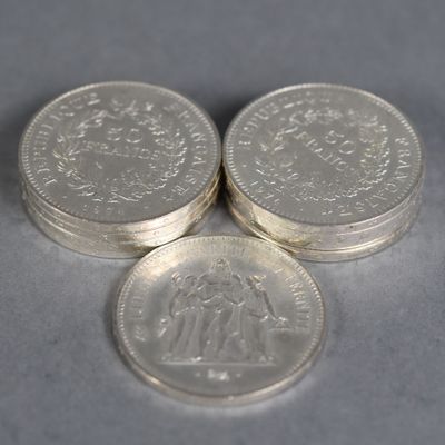 three silver coins sitting on top of each other on a table