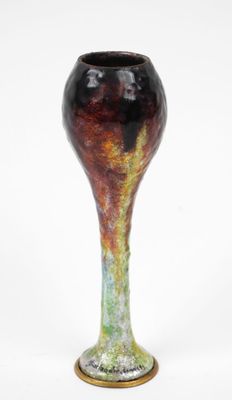 a vase that is sitting on a white surface