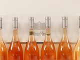 six bottles of wine are lined up in a row in front of a box