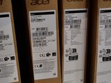 boxes of acer products are stacked on a shelf in a store