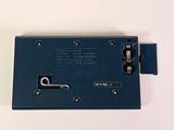 a close up of a blue device on a white surface