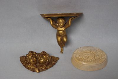three pieces of art that are sitting on a table