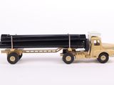a toy truck with a large pipe attached to it