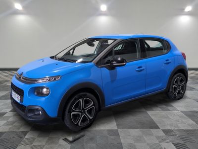 a blue citrole car parked in a showroom