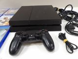 a close up of a video game console with two controllers and a charger