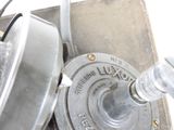 a close up of a metal object on a white surface