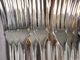 a lot of forks that are sitting on a table