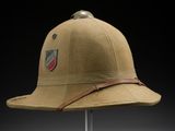 a close up of a hat on a stand on a black background