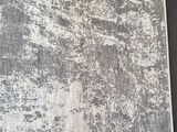 an image of a gray and white rug on a black surface