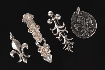 a group of silver metal items on a black surface