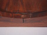 a clock that is sitting on top of a wooden shelf