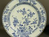 a blue and white plate with flowers on it