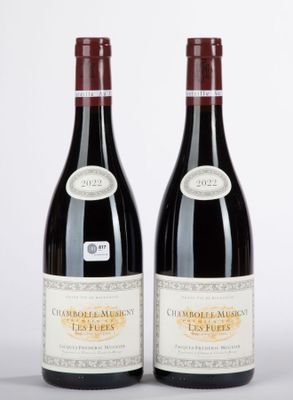 two bottles of red wine sitting next to each other on a table