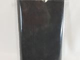 a black cell phone in a plastic bag on a white surface