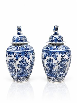 pair of chinese blue and white vases with lids