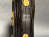 a black and gold cabinet with two doors on it