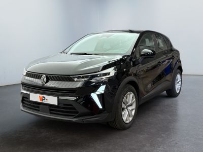 the black car is parked in a room with a white wall