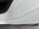 a close up of a white car with the door open