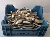 a blue container filled with silverware on a white table