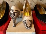 several pairs of shoes are lined up on boxes in a room
