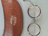 a pair of glasses and a pair of eyeglasses on a table