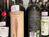 several bottles of wine are lined up on a counter