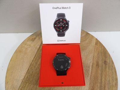 the watch is in the box on the table next to the box
