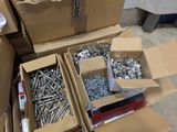 many boxes of screws and bolts on the floor