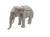 statue of an elephant with a saddle on its back on a white background