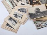 a pile of old photographs sitting on a table