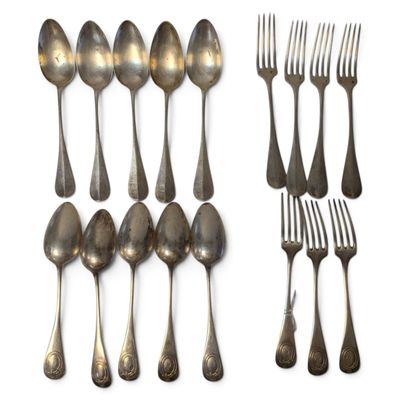 many spoons and forks on a white surface
