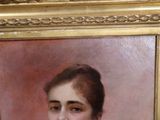 portrait of a woman in a white dress and a gold frame