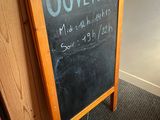 a chalk board with a sign that says ouvertt on it