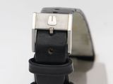 a close up of a watch with a black strap