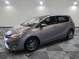 the toyota yaris is parked on a checkered tile floor