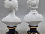 pair of white porcelain busts of women on black bases