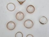 a close up of a bunch of rings on a white surface