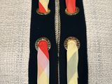 a close up of a woman ' s neck with a colorful tie on it