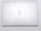 an open laptop computer sitting on top of a white table