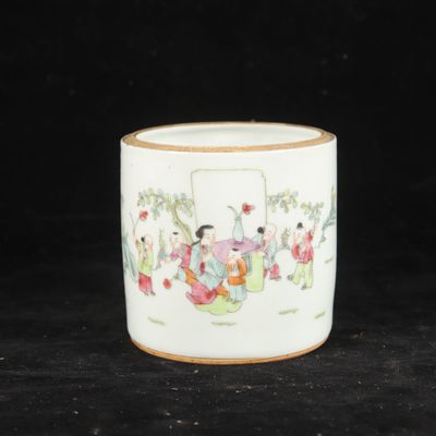 a white cup with a design on it on a black surface
