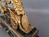 a statue of a man riding a horse drawn carriage