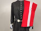 an image of a uniform on a mannequin with a red and white sash