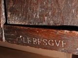 a close up of a piece of wood with a sign on it