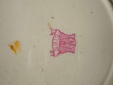 a white plate with a pink design on it