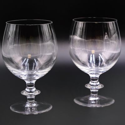 two empty wine glasses sitting next to each other on a table